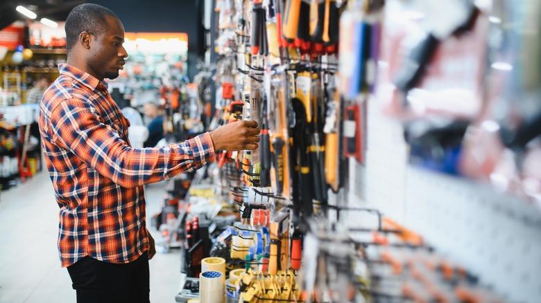 Man browsing through tools at hardware store