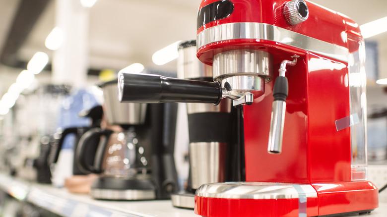 Espresso machine on a shelf with other coffee machines