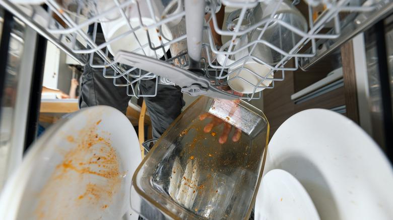 close up of dirty dishes inside dishwasher