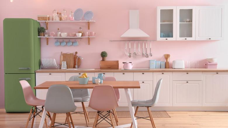 kitchen with pink accent wall and pink, green and blue decor