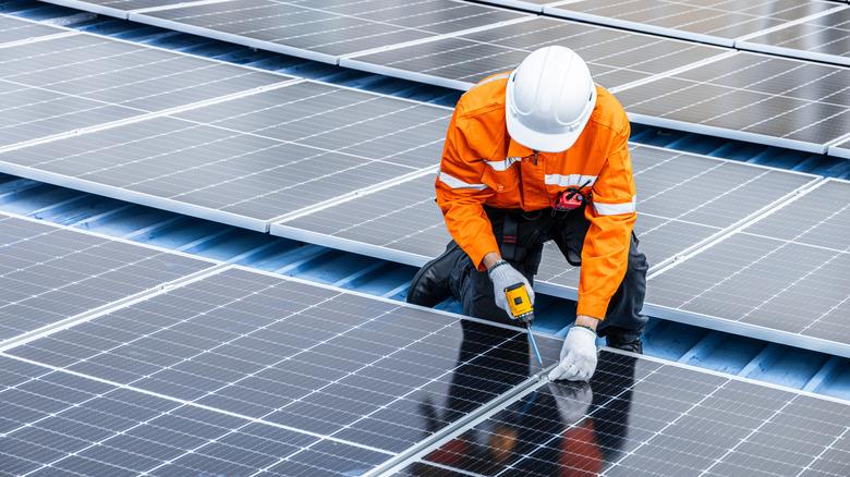 Worker installing solar panels