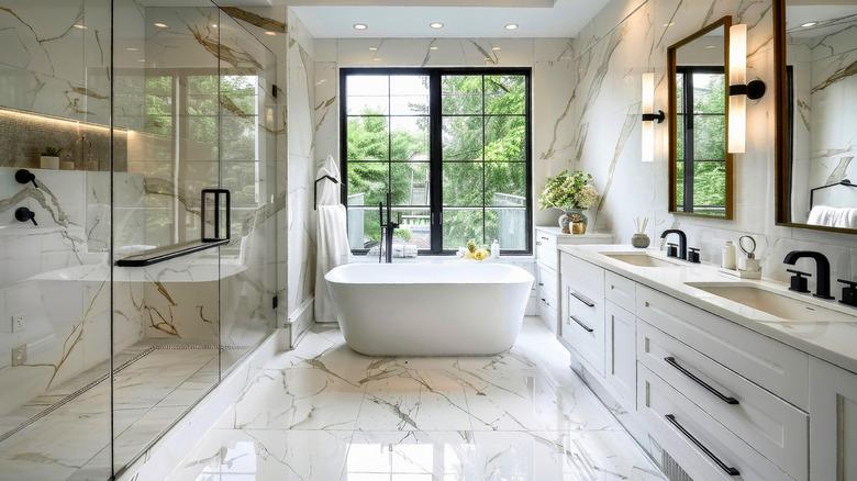 Large bathroom with walk-in shower, double vanities, and freestanding tub