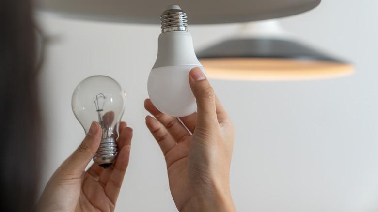 Woman changing light bulbs