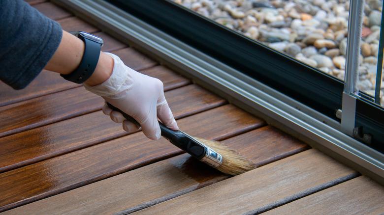 hand applying stain wood