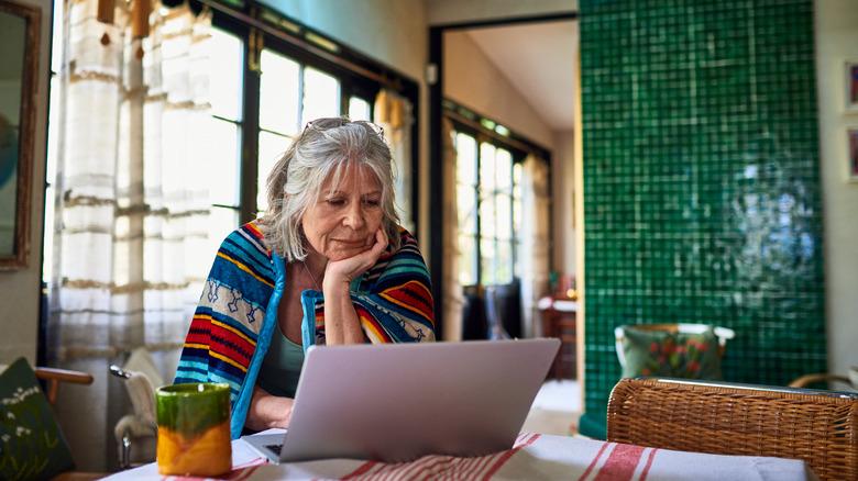 Frustrated woman looking at laptop screen