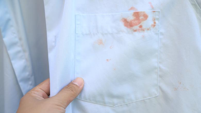 Blood stains on a light blue shirt