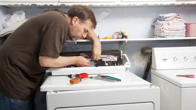 Man repairing clothes dryer