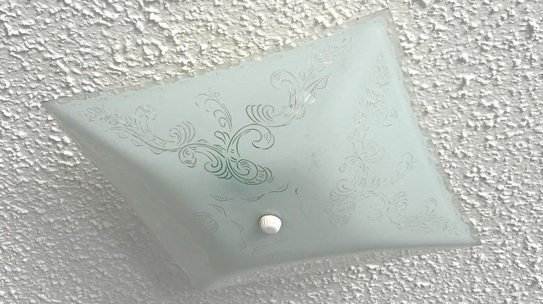 popcorn ceiling texture with a square glass shade light fixture