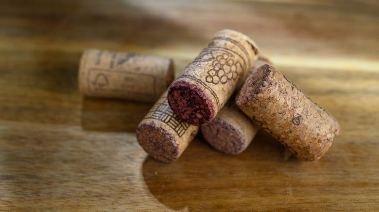 Used wine corks on a wood surface