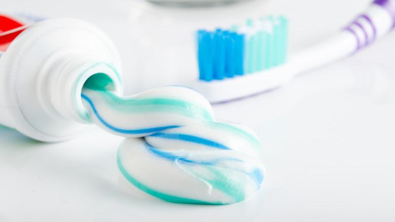 Toothpaste and toothbrush against white background