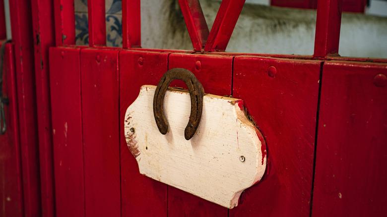 Rusty horseshoe hanging on door
