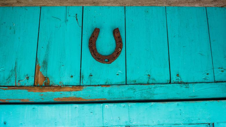 Rusty horseshoe hung on top of door