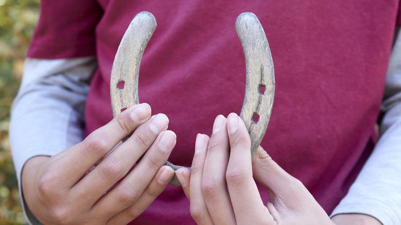 Person holding a horseshoe