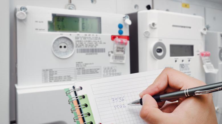 Person monitoring their energy usage at their meter