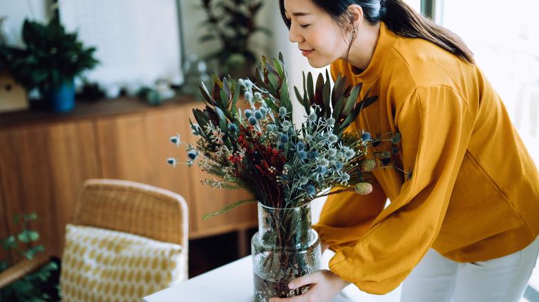 woman with a vase full of flowers