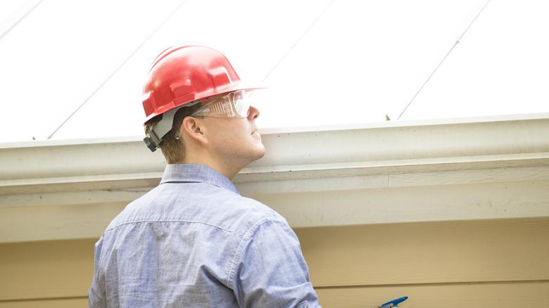 Inspector or appraiser examining a roof