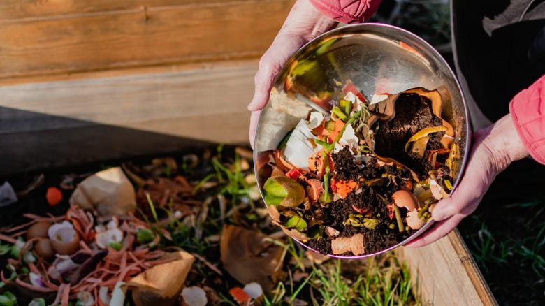 Adding coffee grounds to a compost bin