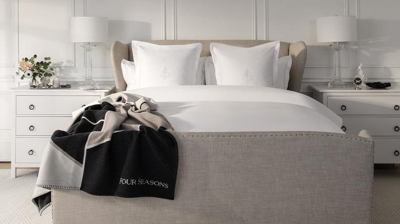 Four Seasons Hotel bed made up with white linens