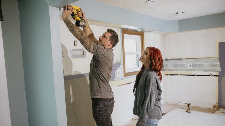 Cole and Chelsea DeBoer using power tools in the midst of a home renovation