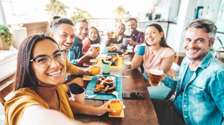 happy people sitting around a large rectangular table