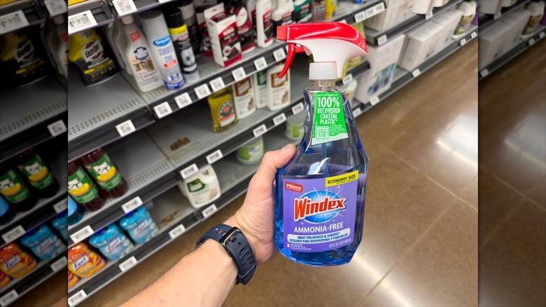 Man holding ammonia-free Windex in cleaning aisle