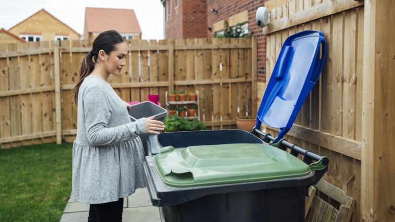 woman with tidy trash bins