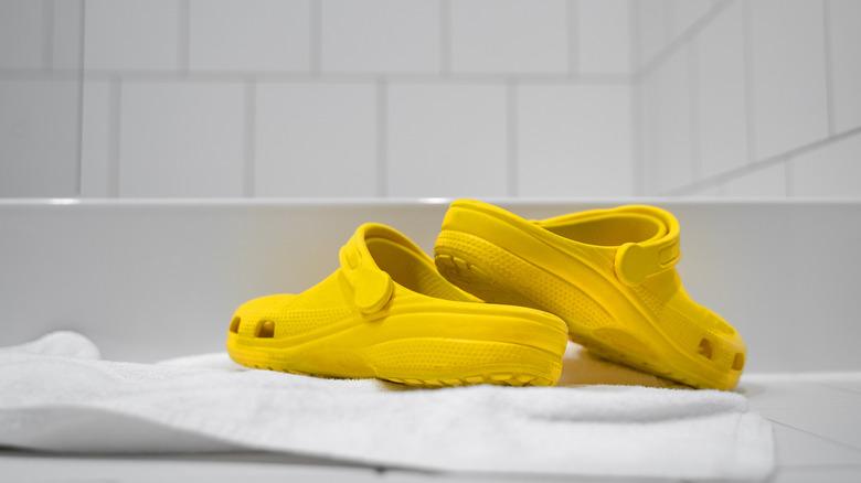 yellow crocs on towel white background