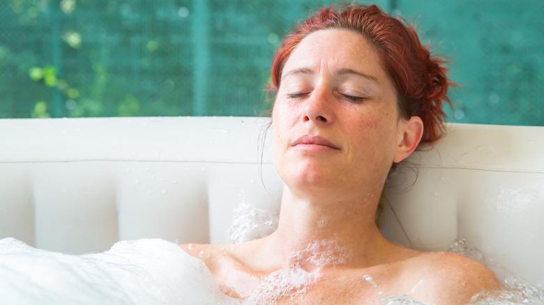 Woman relaxing in an inflatable hot tub.