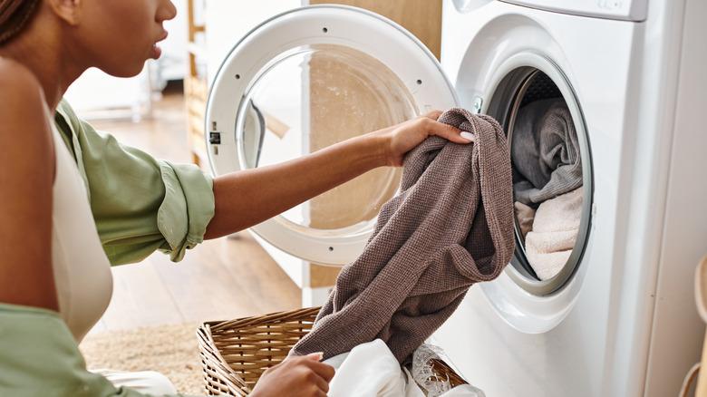 woman pulling clothes from dryer