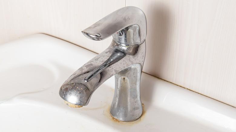 water faucet with hard water stains, rust, and build up