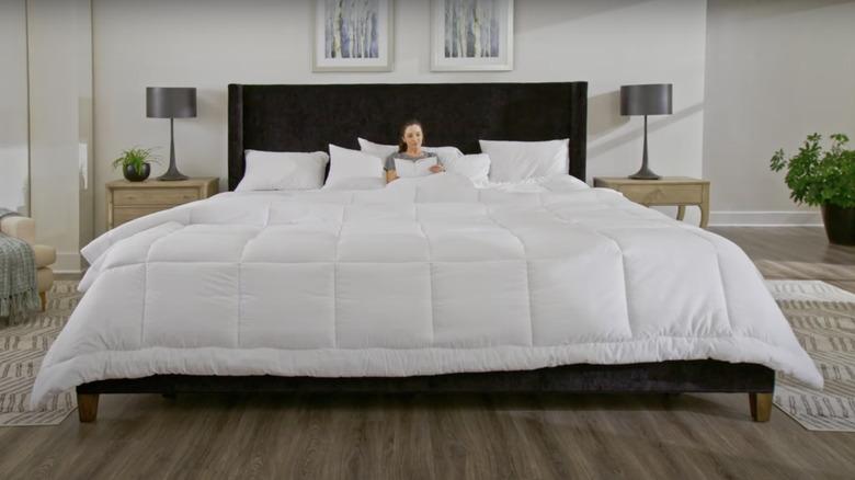 woman reading in oversized king bed