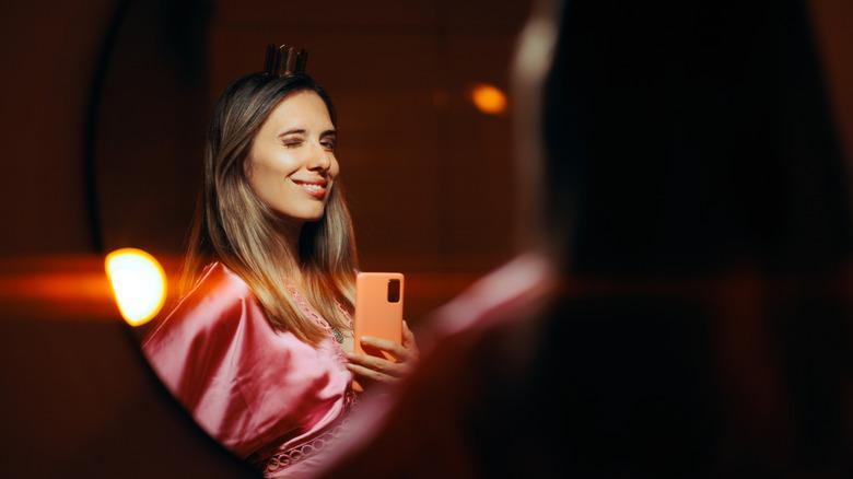 woman taking selfie in mirror