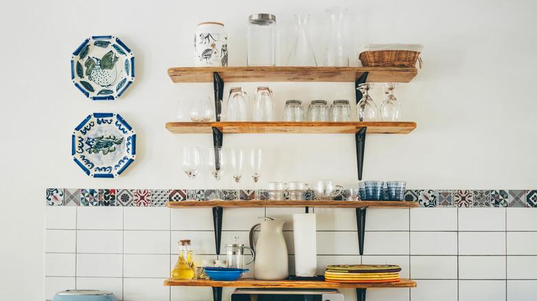 wall shelves added to kitchen wall for drink and dishware