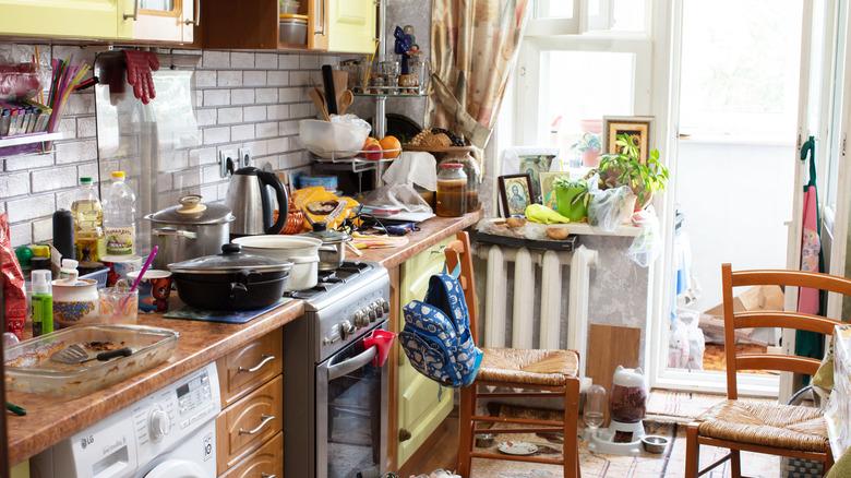 Small, cluttered kitchen with dirty dishes