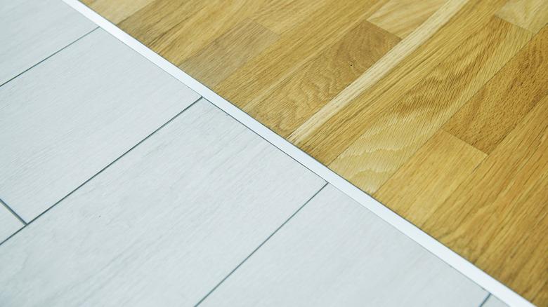 Wood floor meets tile floor with a flush aluminum transition