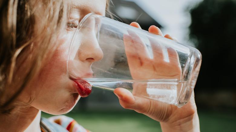 Person drinking a glass of water
