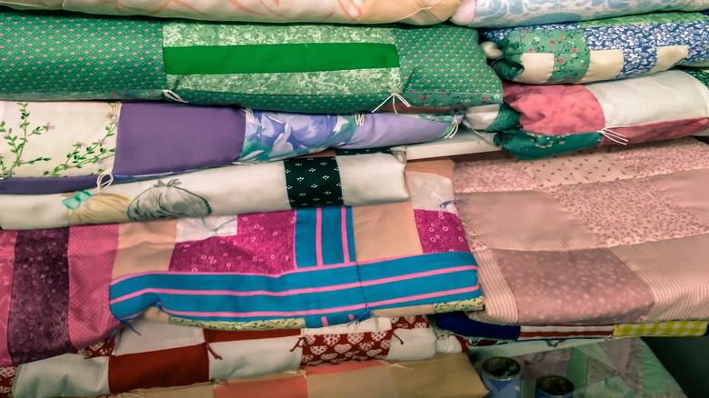 stack of handmade quilts