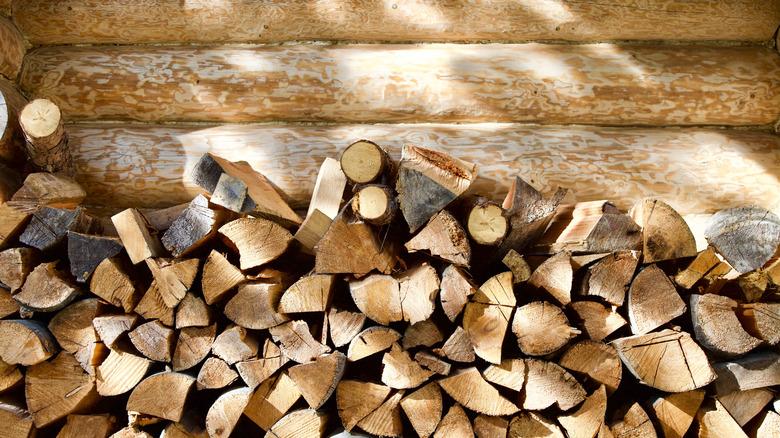 Firewood stacked against log house