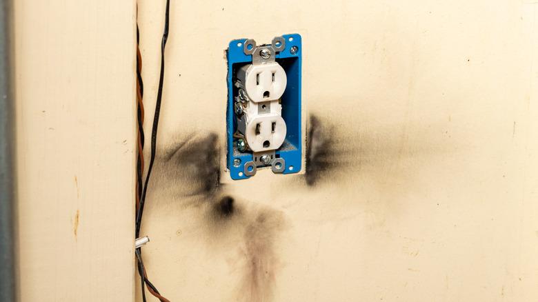 Electric receptacle surrounded by burn marks