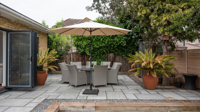 Patio with table, chairs, and umbrella