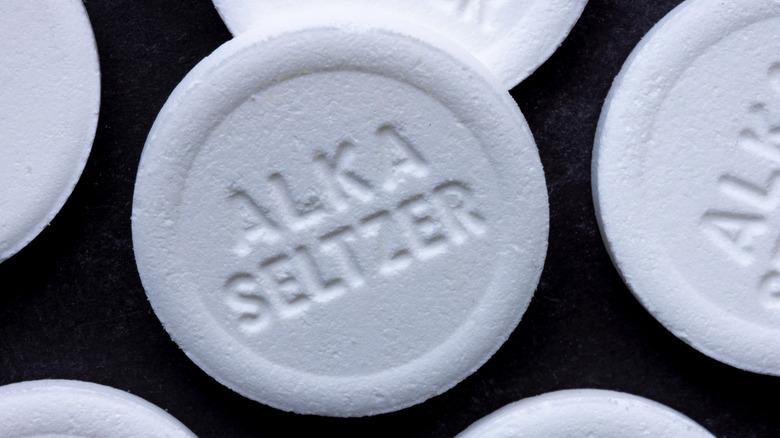 White Alka-Seltzer tablets on a black background