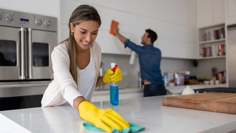 Couple cleaning their home kitchen