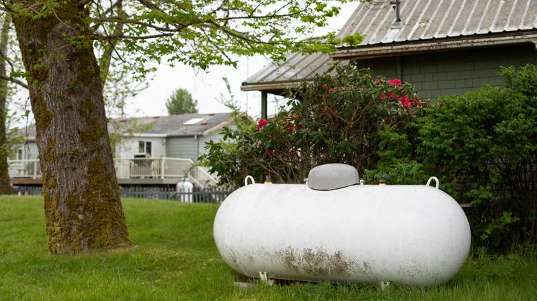 large propane tank next to home