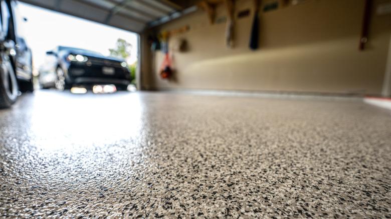 Epoxy coating in garage visible with car driving in