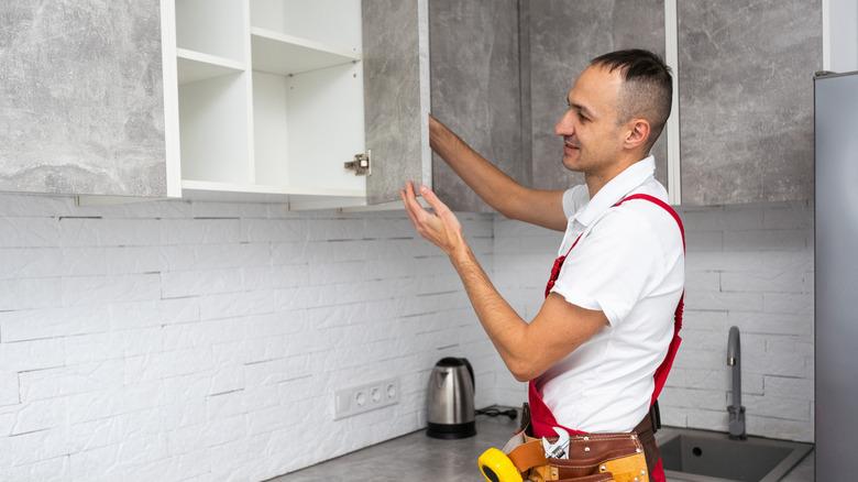 Man installing a cabinet door