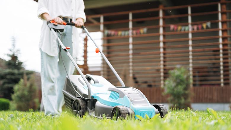 Person pushing a lawn mower