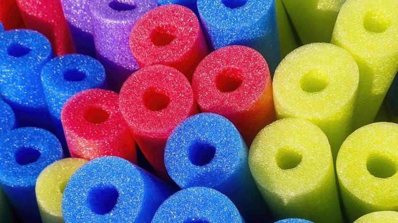 a bunch of pool noodles showing hollow ends