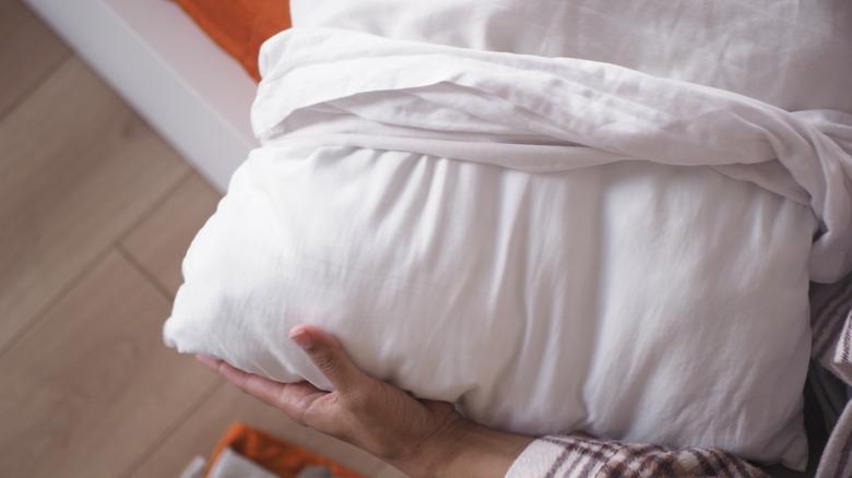 Person removing pillow from case