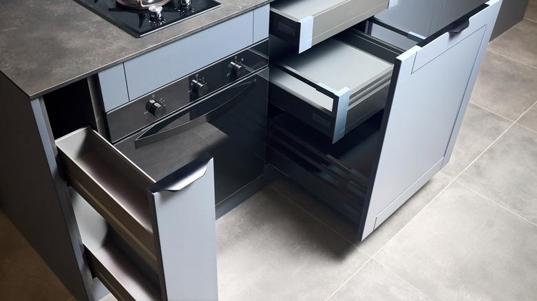 close up of stove with vertical pull-out drawers on each side of the oven