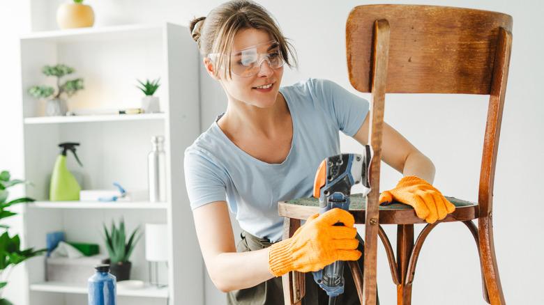 Woman using detail sander